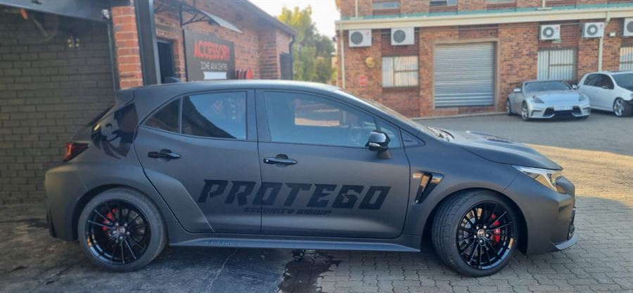 A vehicle finished in a matte fleet wrap with cut vinyl branding on the door