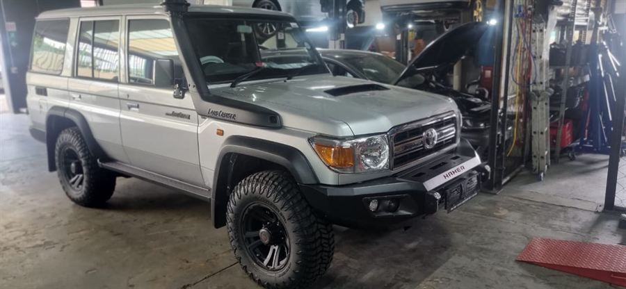 A Toyota Land Cruiser 79 on the workshop floor with a Hamer front bumper and snorkel fitted